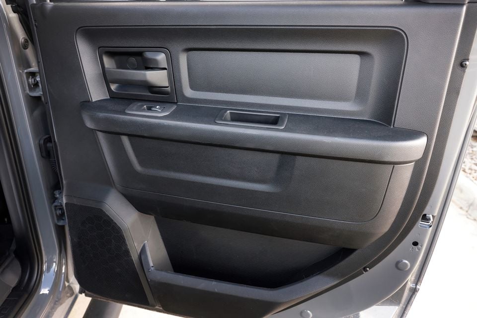 Close-up of the black door trim panel with armrest and speaker inside a 2026 Ram 2500 Warlock ute