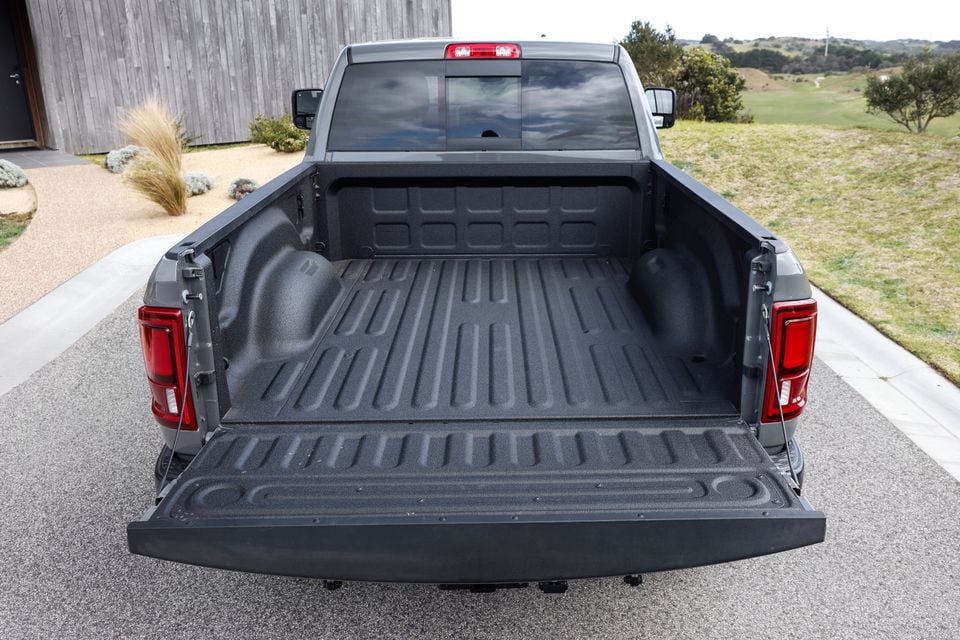 The open tailgate and empty tray of a silver 2026 Ram 2500 Warlock ute, viewed from directly behind