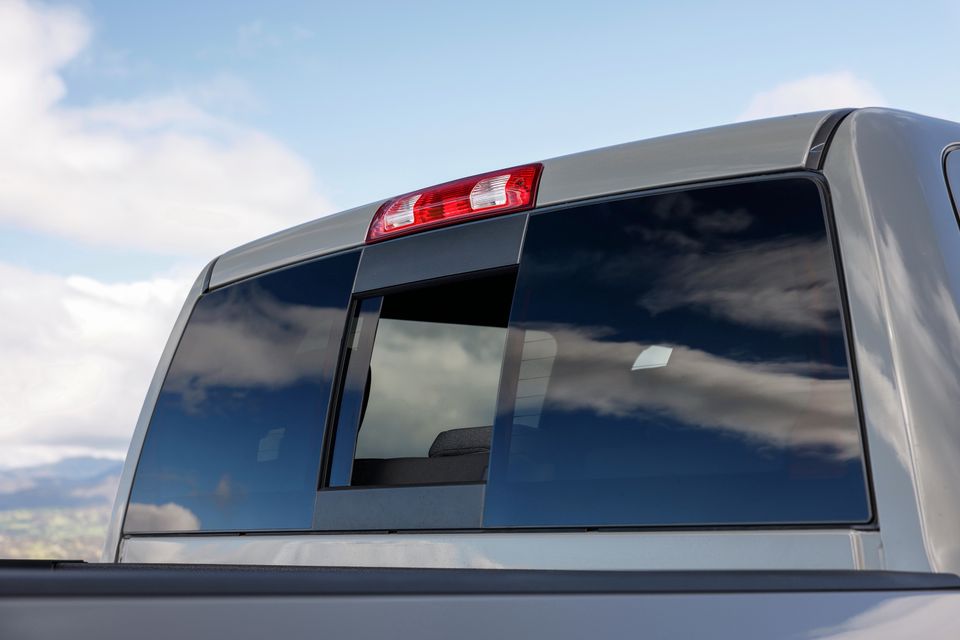 Close-up of the rear window and third brake light on a silver 2026 Ram 2500 Warlock pickup truck's cabin