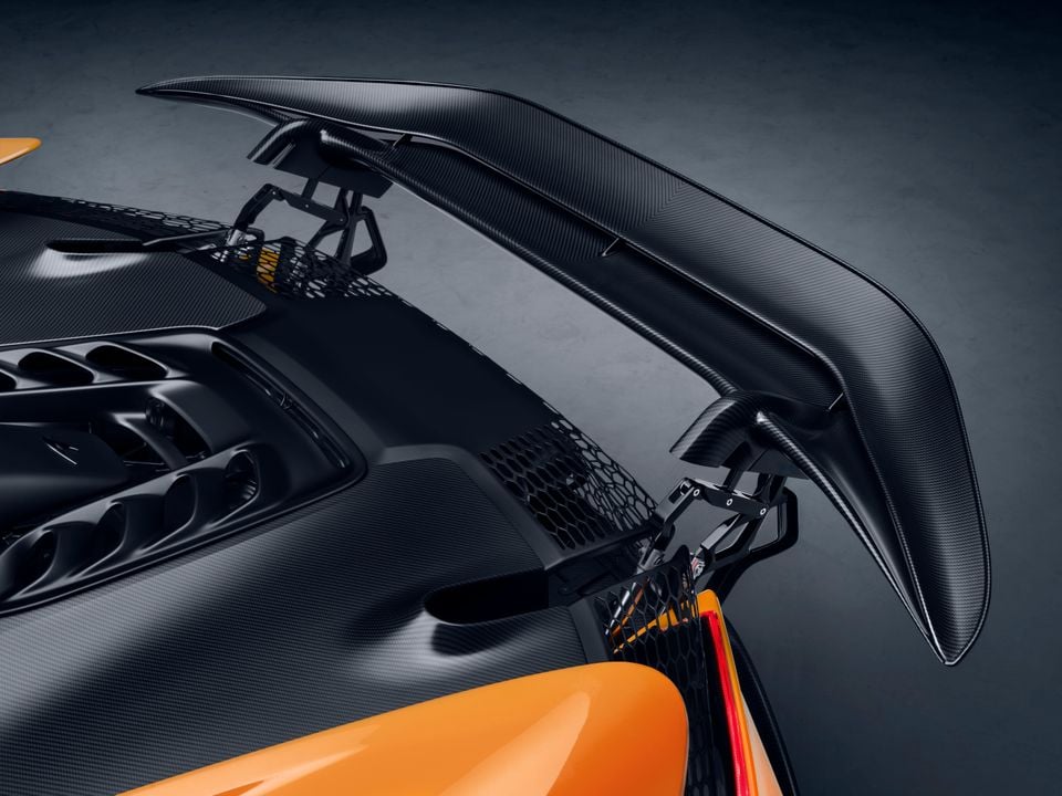Close-up of the large carbon fibre rear wing on the McLaren W1 supercar, finished in orange with exposed carbon bodywork