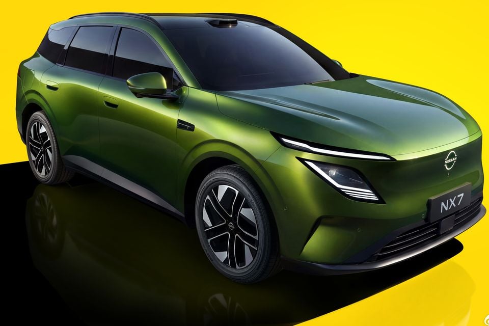 A green Nissan NX7 SUV shown from the front three-quarter angle against a yellow background