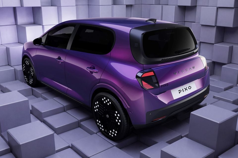 A purple 2027 Nissan Pixo hatchback shown from the rear quarter in a studio setting with cube-patterned walls