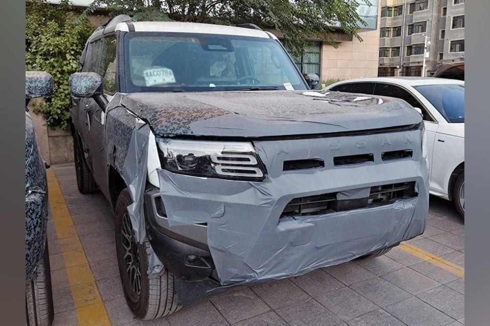 A camouflaged SUV, believed to be a Nissan Terrano prototype, photographed from the front while parked on a street.