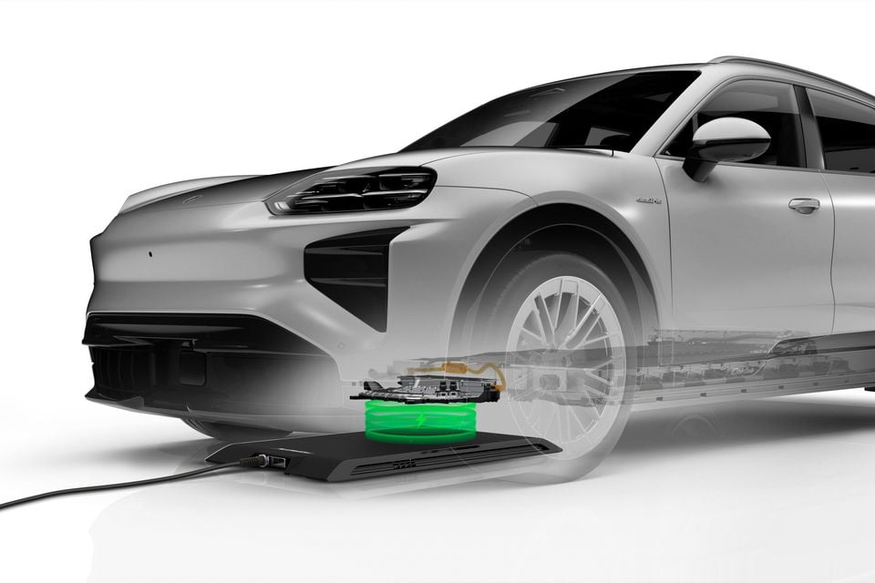 A Porsche Cayenne Electric prototype shown with a transparent body revealing a wireless charging pad glowing green beneath the front underbody.