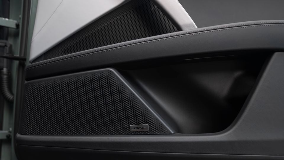 Bose speaker grille on the door panel interior of a Porsche Cayenne Turbo E-Hybrid