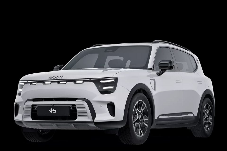 A white Smart #5 SUV shown from a front three-quarter angle against a black background