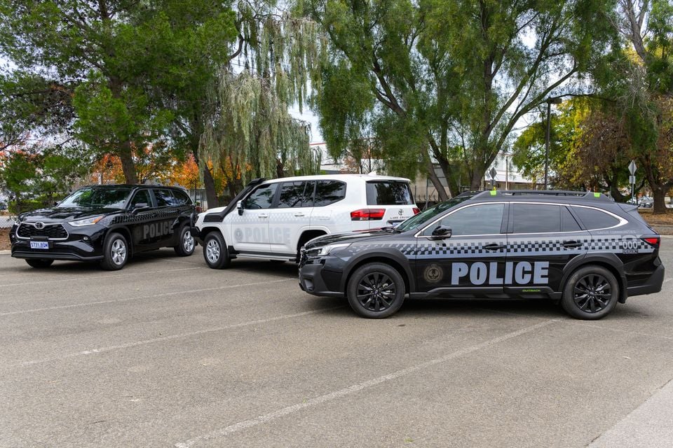 Three South Australia Police SUV patrol cars parked in a car park, including a Subaru Outback, Toyota Kluger, and Toyota LandCruiser in black and white police livery