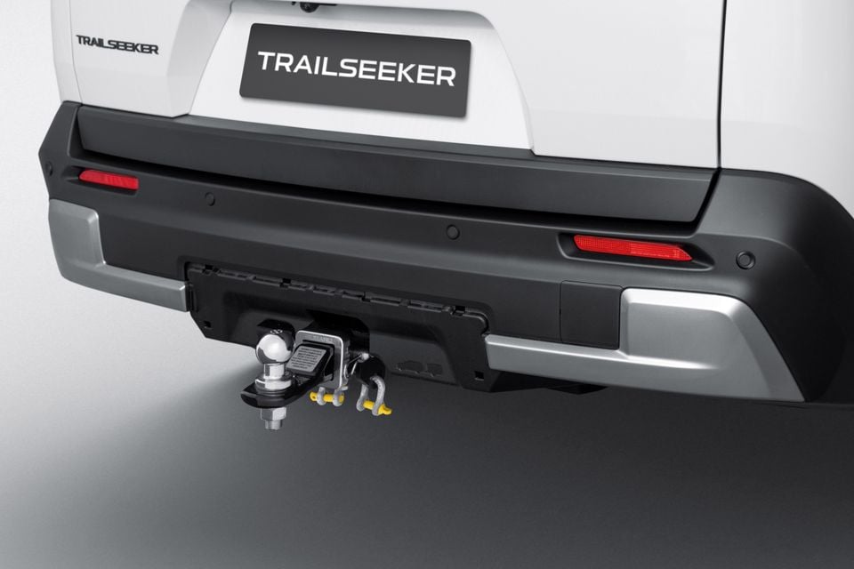 Close-up of the rear bumper and tow bar on a white Subaru Trailseeker SUV, showing a ball hitch and recovery shackles