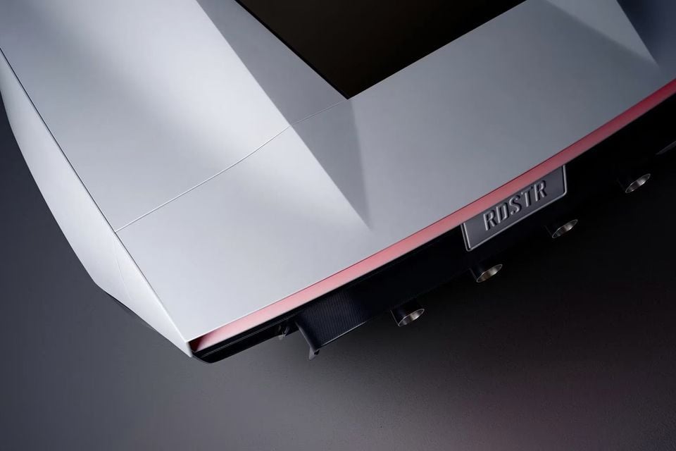 Elevated close-up of the silver Tesla Roadster's rear deck, showing a pink light bar, RDSTR number plate and carbon-fibre diffuser