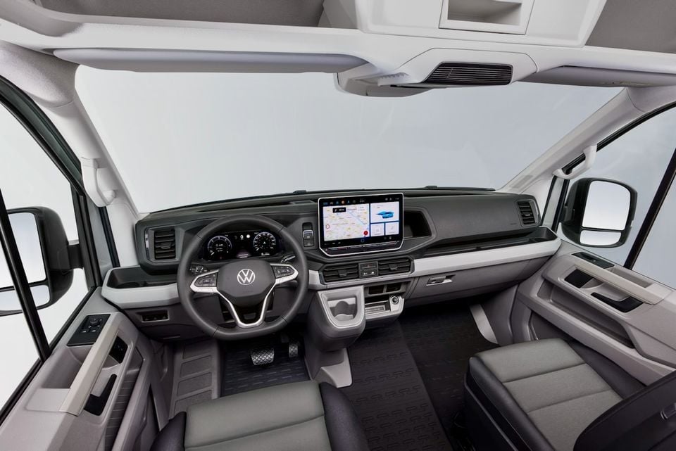 Interior of a Volkswagen Crafter van showing the dashboard, steering wheel, digital instrument cluster, and large central touchscreen infotainment display