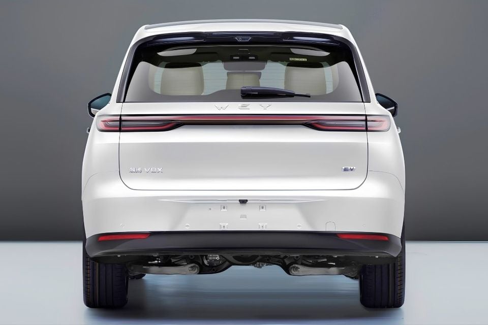 Rear view of a white WEY V8X electric SUV in a studio setting