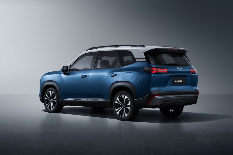 A blue Wuling Eksion SUV shown from the rear quarter in a studio setting