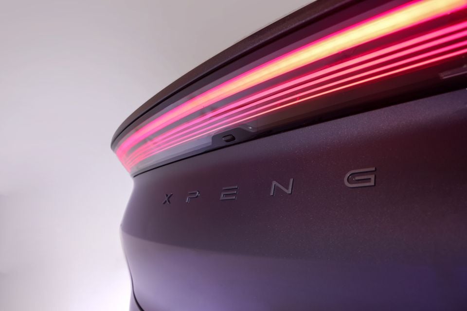 Close-up of a purple Xpeng car's rear taillight strip and badge on the tailgate