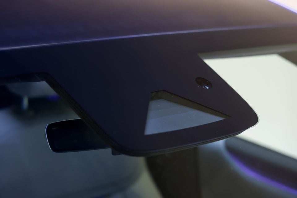 Close-up of a Xpeng L03's front corner showing a sensor and headlight housing detail