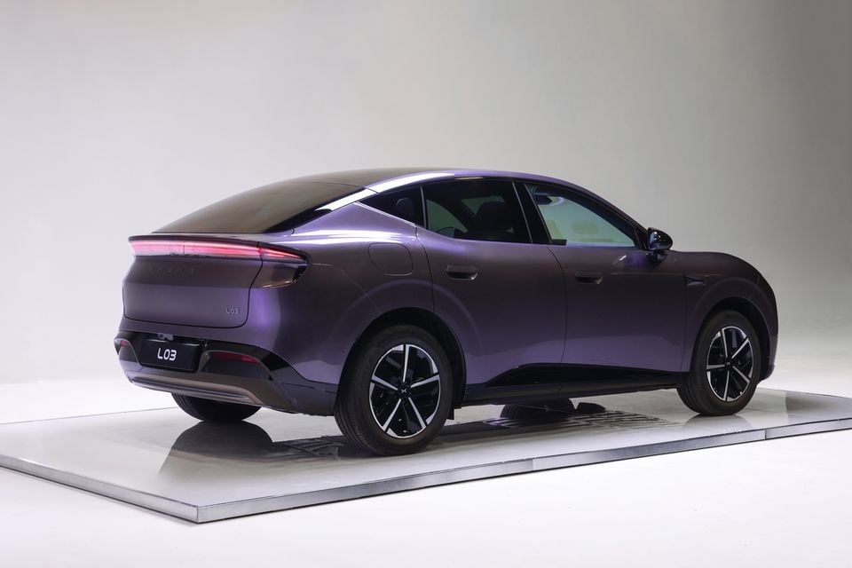 A purple 2026 XPeng L03 sedan photographed from the rear quarter in a studio setting.