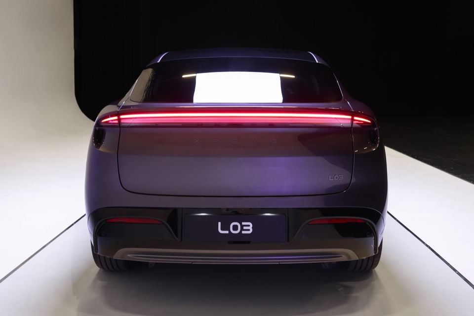 A purple Xpeng L03 sedan shown from directly behind in a studio setting with its tail-light bar illuminated