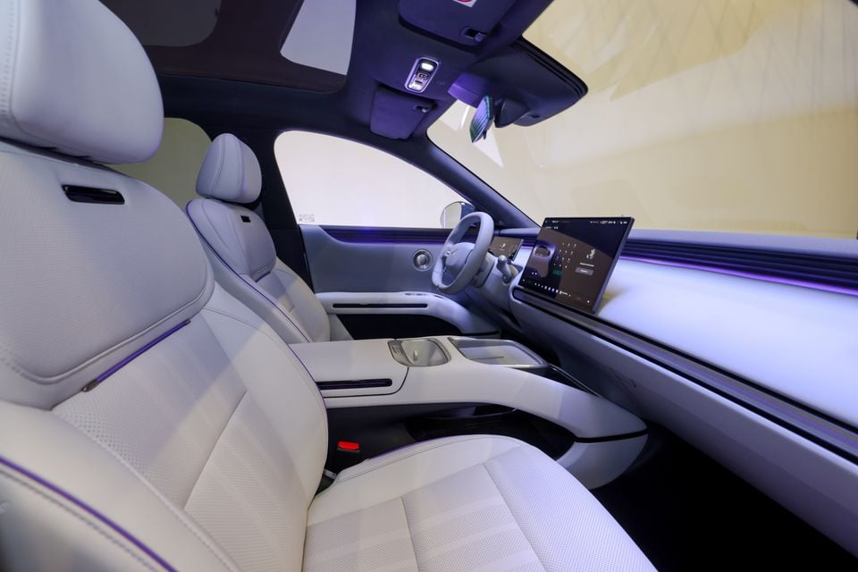 The white leather interior of a 2026 XPeng L03 SUV, showing the front seats, steering wheel, centre console and dashboard touchscreen.