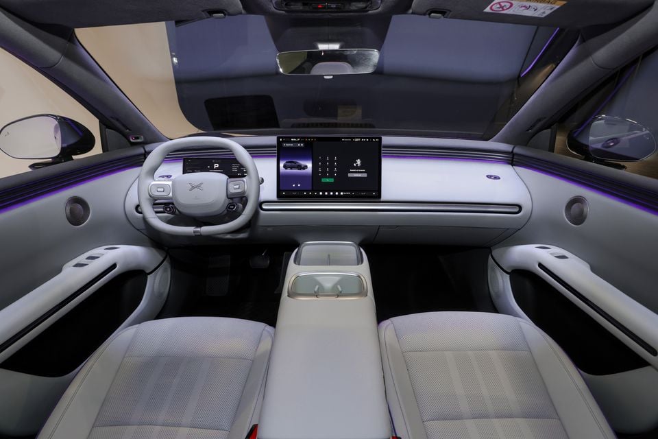 The grey interior of a 2026 XPeng L03 SUV, showing the dashboard, steering wheel, touchscreen and front seats.