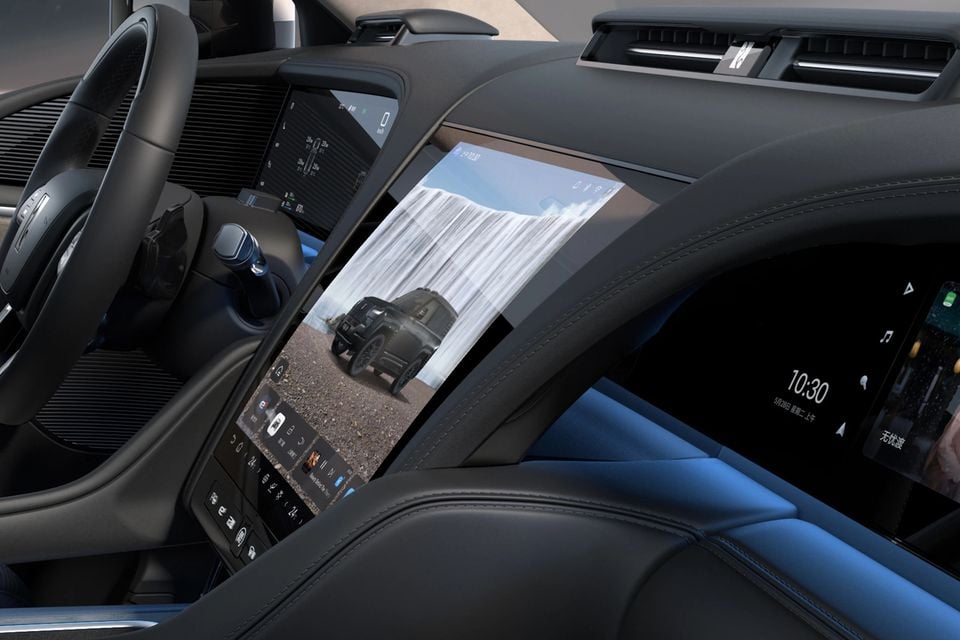 Dashboard of the Yangwang U8 with a large portrait central touchscreen, driver's display, passenger screen and black and blue leather trim