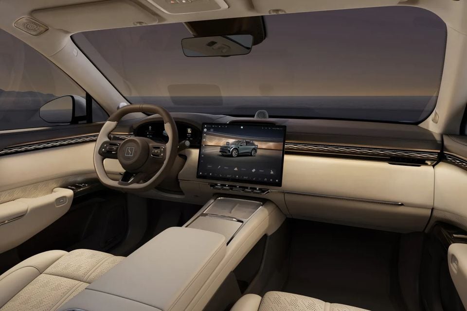 Interior of the Zeekr 7X showing the dashboard, large central touchscreen infotainment system, steering wheel, and cream leather seats