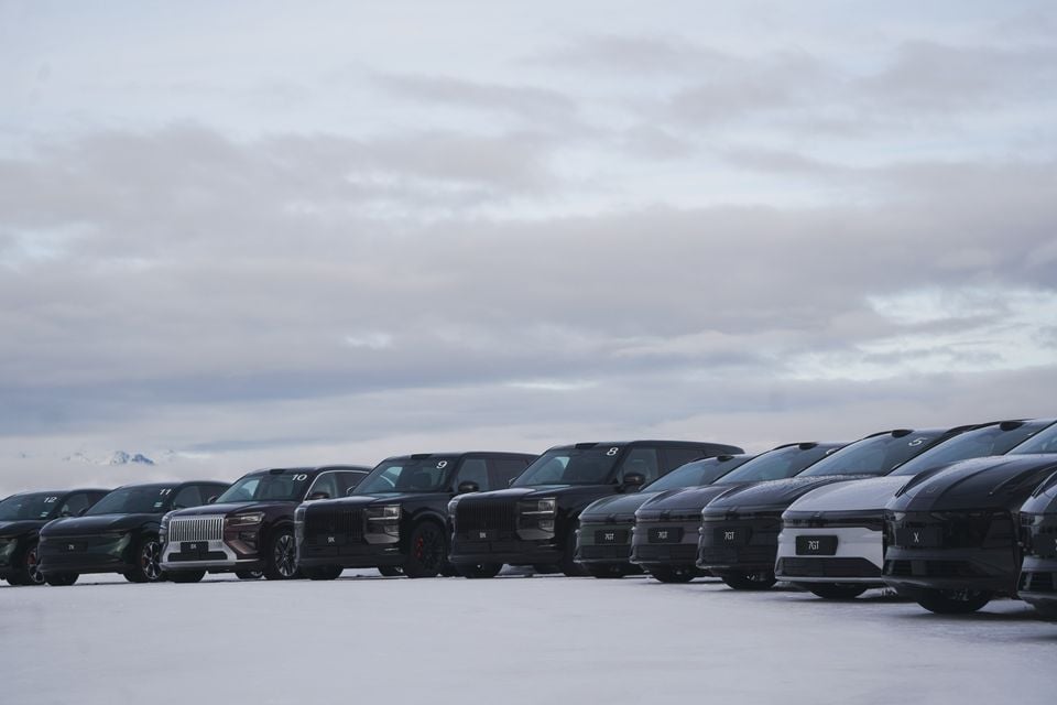A lineup of Zeekr electric SUVs, including the 8X, 9X, 7GT and X models, parked on a snow-covered surface under an overcast sky