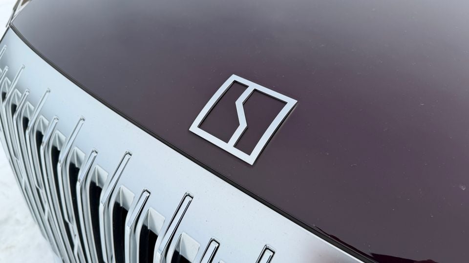 Close-up of the Zeekr badge and front grille on a dark-coloured Zeekr SUV
